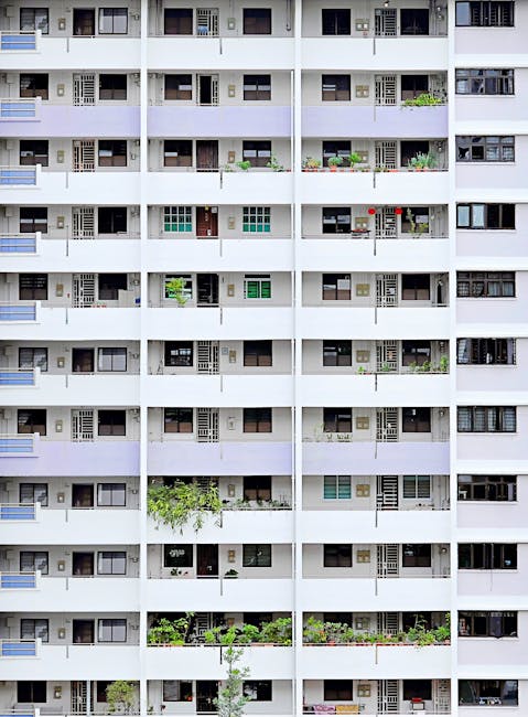 Vertical view of a Singaporean residential block showcasing balconies and uniform architecture.