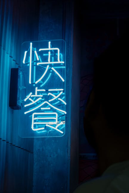 A vibrant neon sign in Buenos Aires, Argentina, illuminating a dark alley.